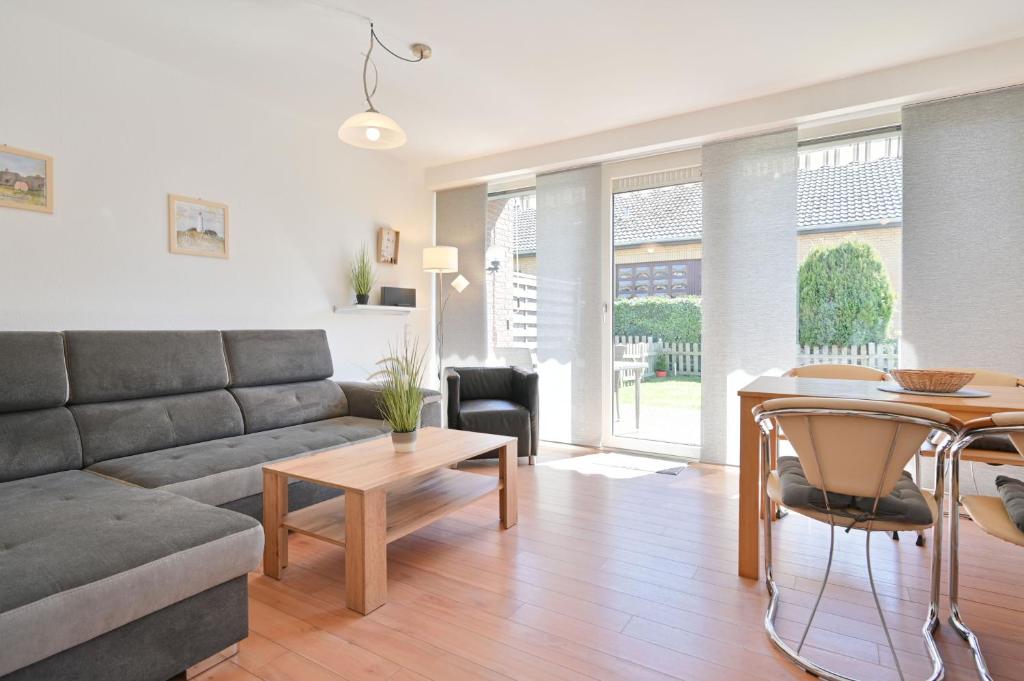 a living room with a couch and a table at Ferienhaus Keona Im Winkel in Dahme