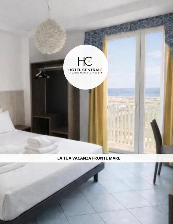 a bedroom with a bed and a large window at Hotel Centrale FRONTE MARE in Milano Marittima
