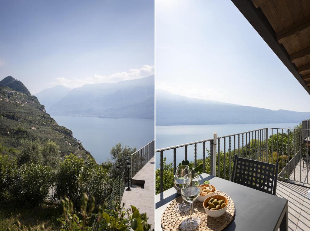 a table with wine glasses and a view of a mountain at Albicocca in Tignale
