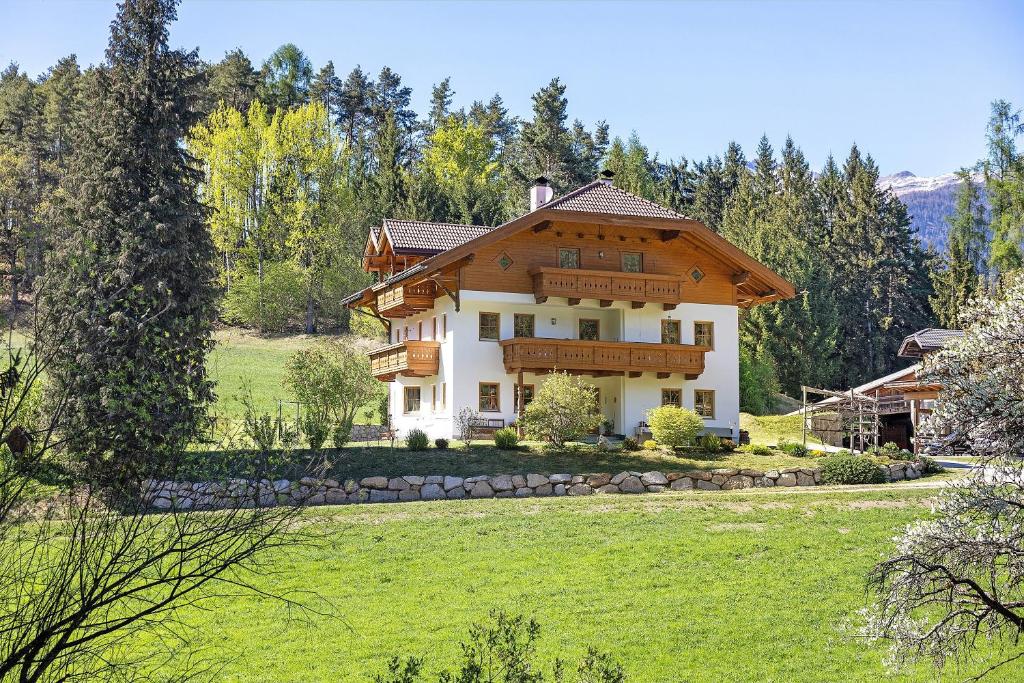 a house in the middle of a field at Getzenbergerhof in Chienes