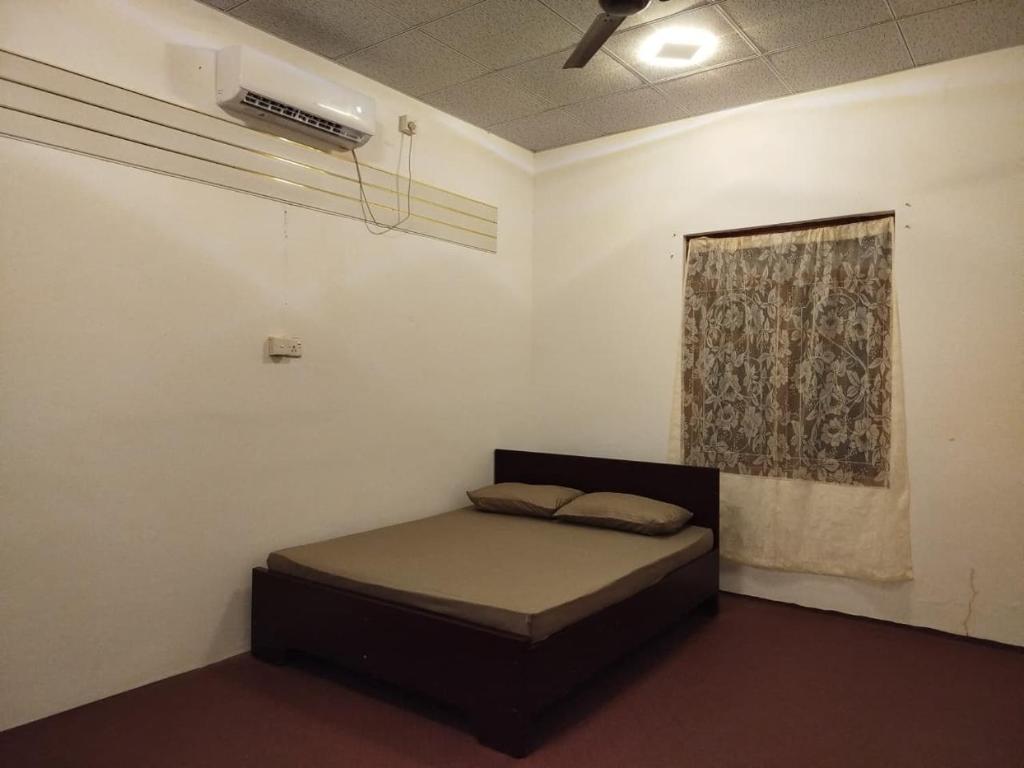 a bedroom with a bed in a room with a window at Aqua Dream Adventures Resort in Trincomalee