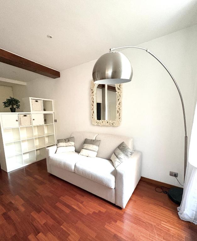 a living room with a white couch and a mirror at Urbana Lodge, Monti in Rome