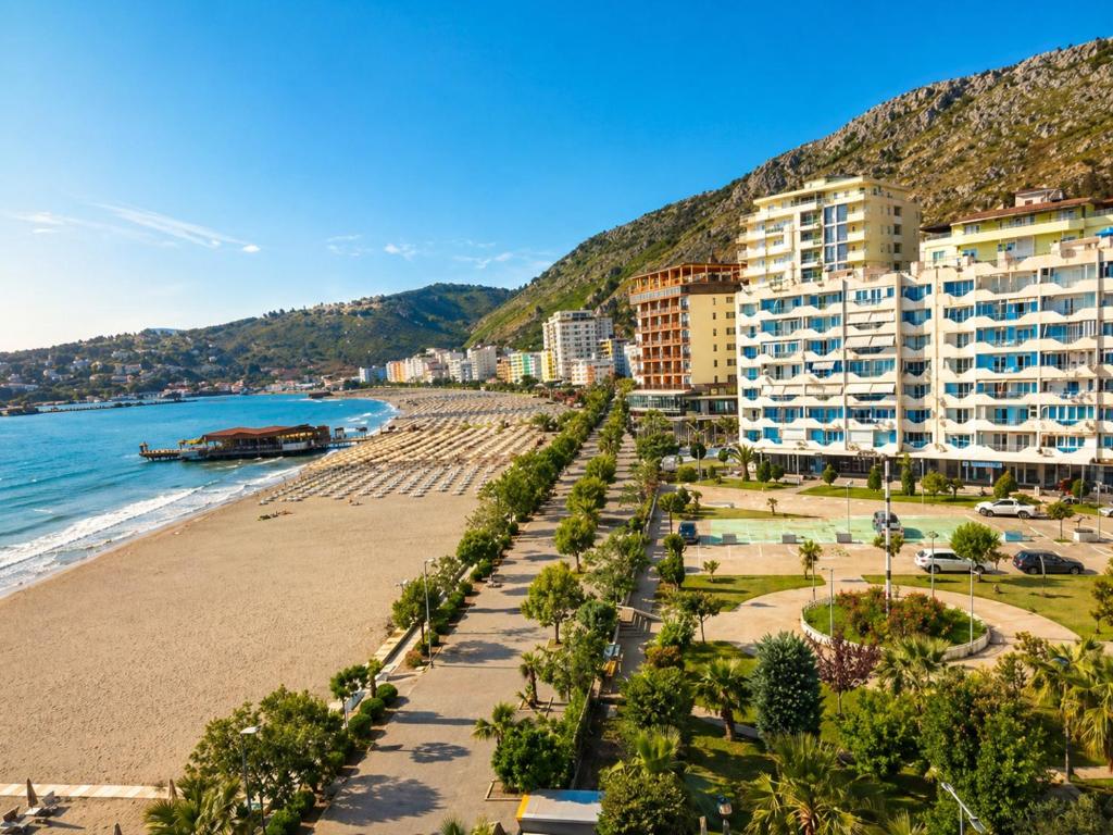 a view of a beach with buildings and the ocean at Sea view apartment 1 in Shëngjin
