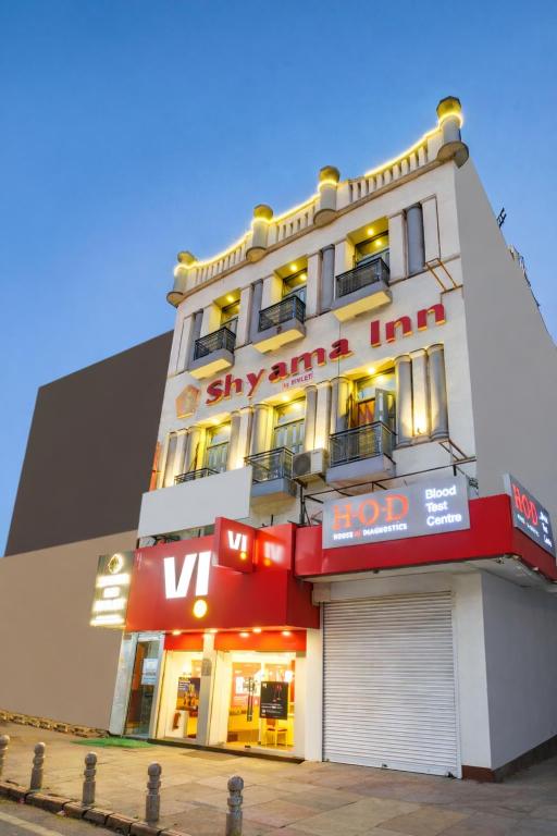 a large white building with a sign on it at Shyama Inn by Rivlet, Delhi in New Delhi