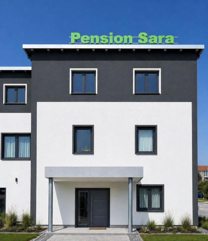 a black and white building with a retention saa sign on it at Pension Sara in Magdeburg