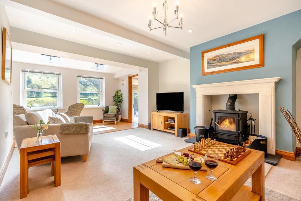 a living room with a couch and a fireplace at 3 Bed in Gunnerside oc-ds097 in Gunnerside
