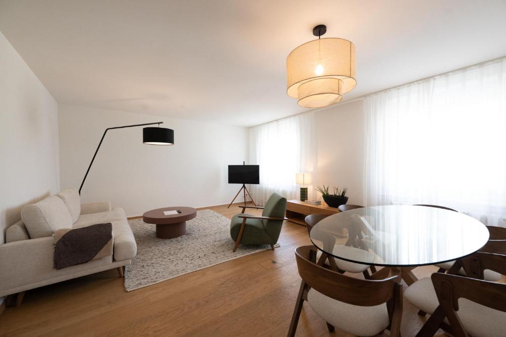 a living room with a table and a couch at Stadtloft Suites Zürich- Oerlikon in Zurich
