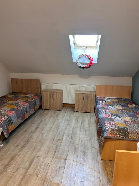 a bedroom with two beds and a window at Cazare Turnisor in Sibiu