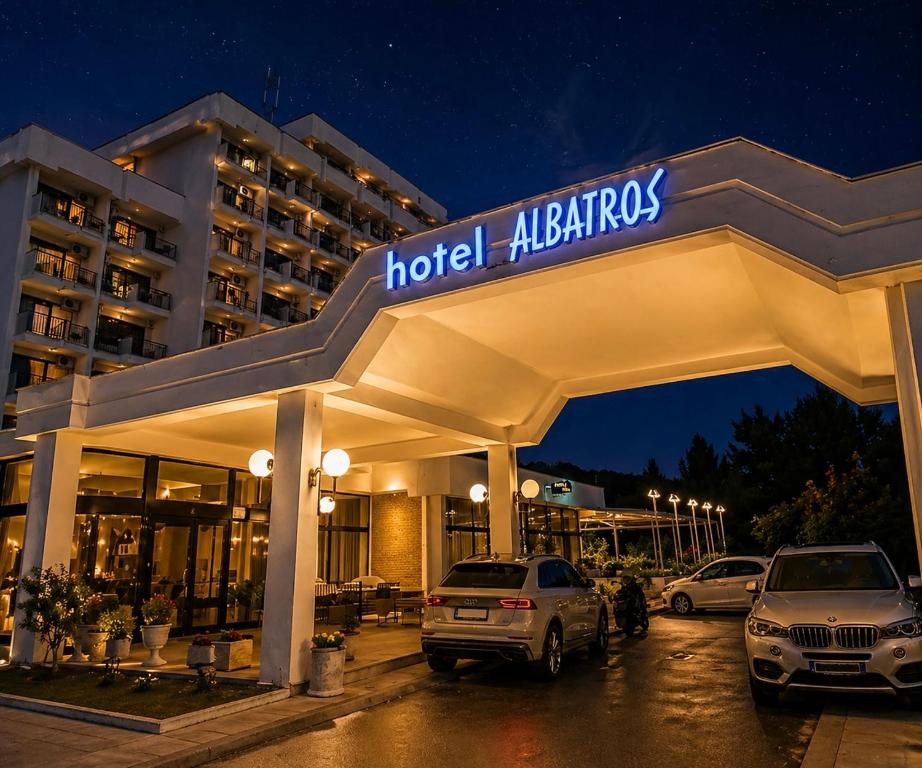 a hotel at night with cars parked in a parking lot at CORPUS B - Hotel Albatros in Ulcinj