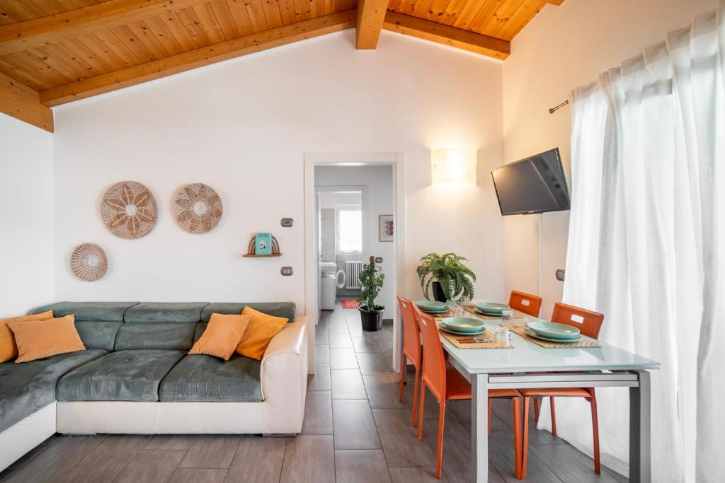 a living room with a couch and a table at Camping Italia 90 Apartments in Domaso