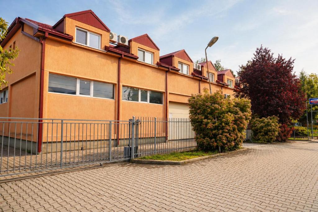 a building with a fence in front of it at Livija rooms in Petrovec