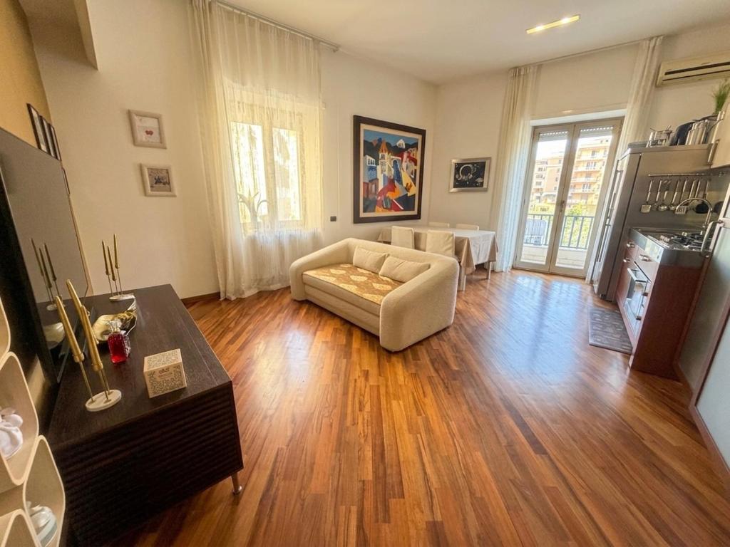 a living room with a couch and a table at ROOMITO apartments in Naples