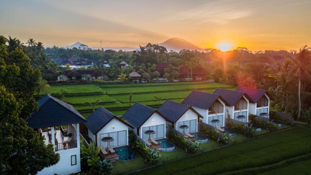a row of houses in a village at sunset at Ascarya Villa Ubud in Ubud