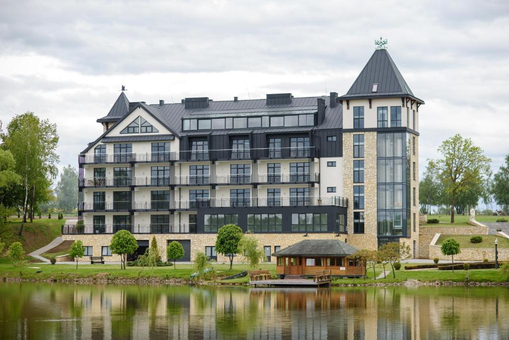 a large building next to a body of water at Kryla by Shepilska in Dolgoluka