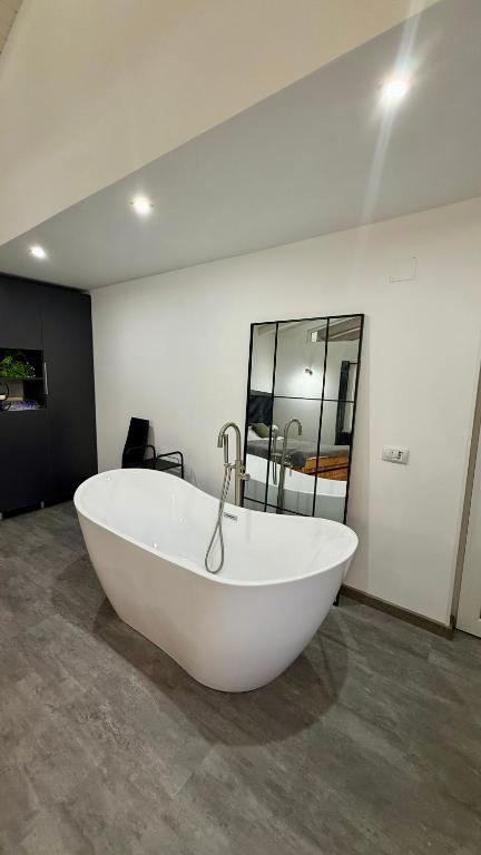 a large white bath tub in a room at Casa Ducaru Moieciu de Sus in Moieciu de Sus