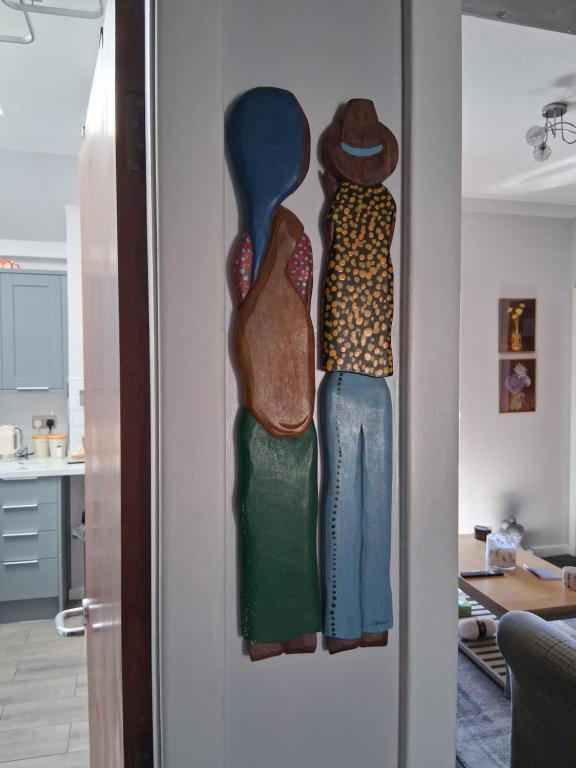 three pieces of art hanging on a wall at DRIFTWOOD coastal holiday flat - newly refurbished with 2 bedrooms in Largs