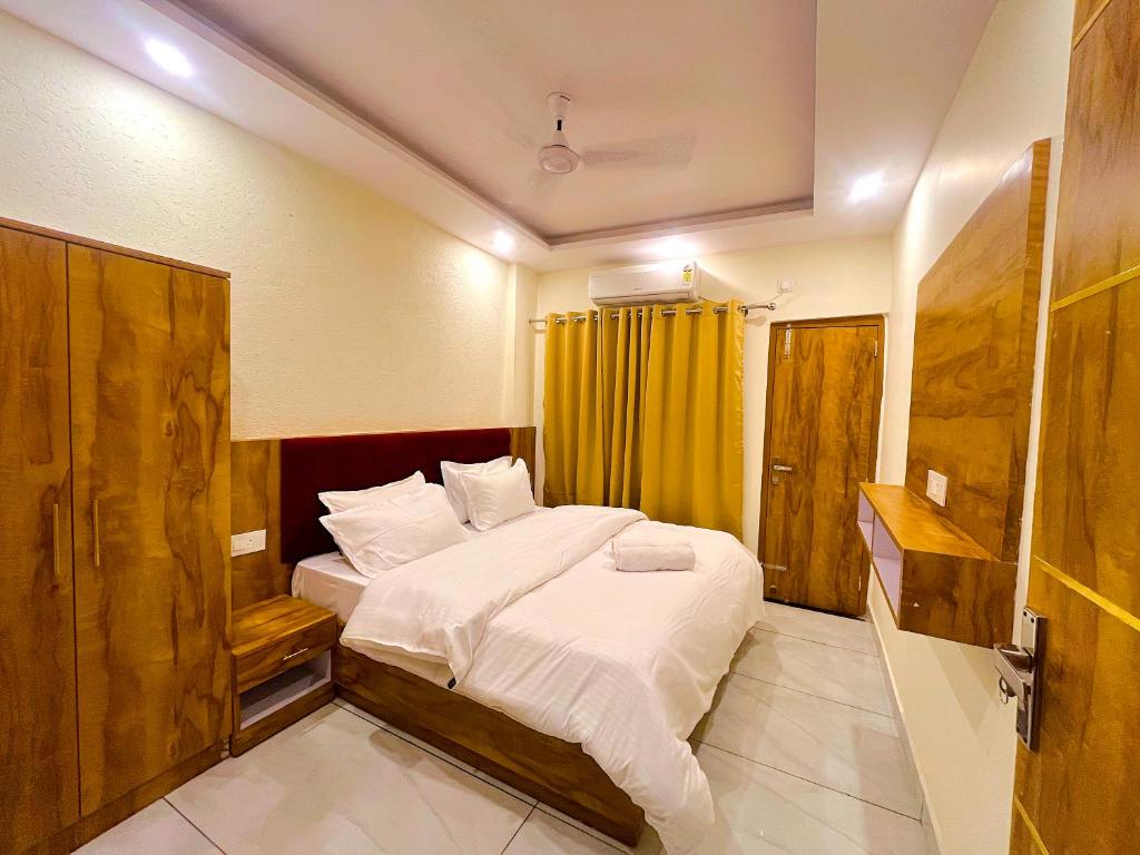 a bedroom with a bed and a yellow curtain at Bunk Hostel Tapovan in Rishīkesh