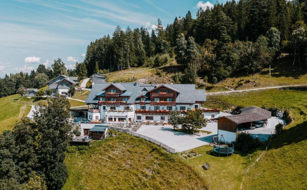 an aerial view of a house on a hill at Hotel Schröckerhof in Schladming