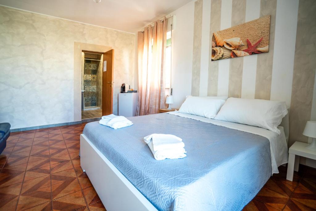 a bedroom with a bed with two towels on it at Casa Immacolata in Polignano a Mare