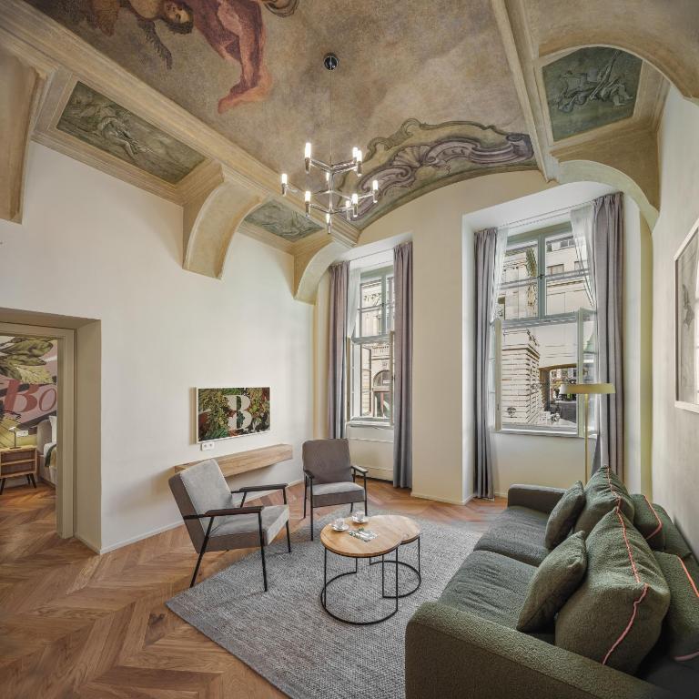 a living room with a couch and a table at The Botanist by Adrez in Prague