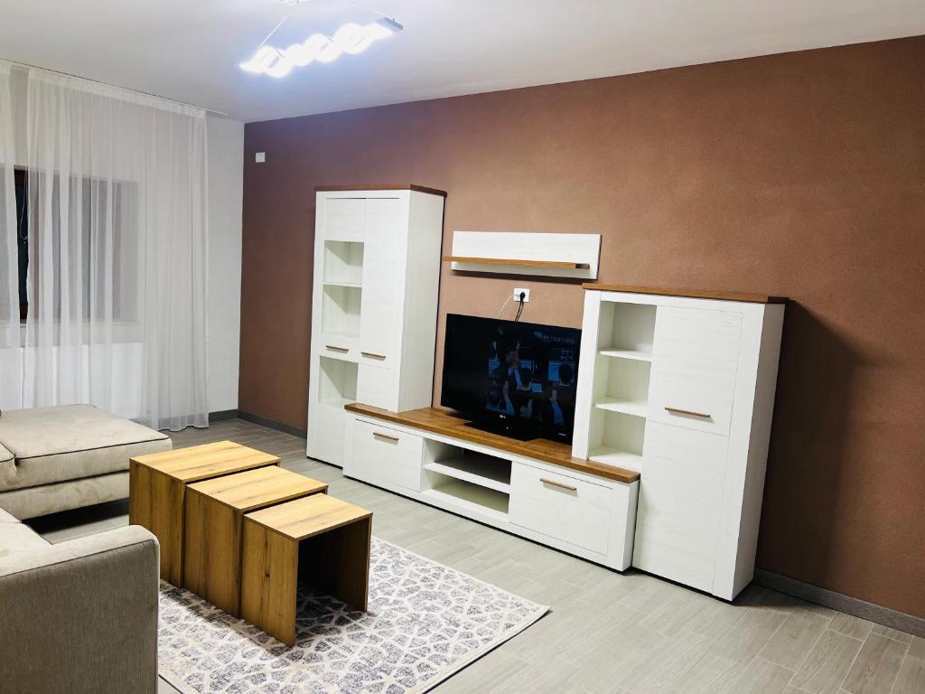 a living room with a couch and a tv at Casa Bradu in Mangalia