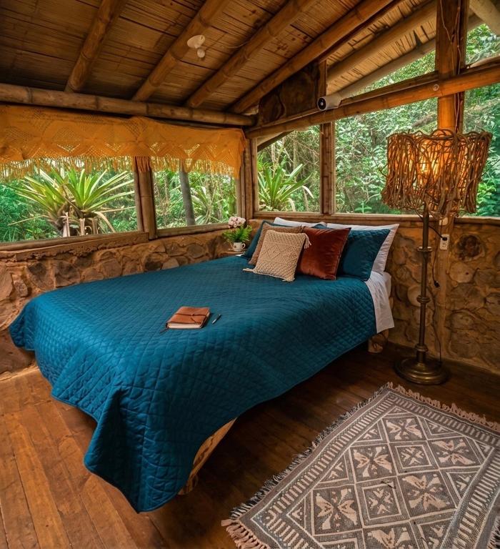 a bedroom with a bed in a tree house at Bosque Hondo Ecoliving in Medellín