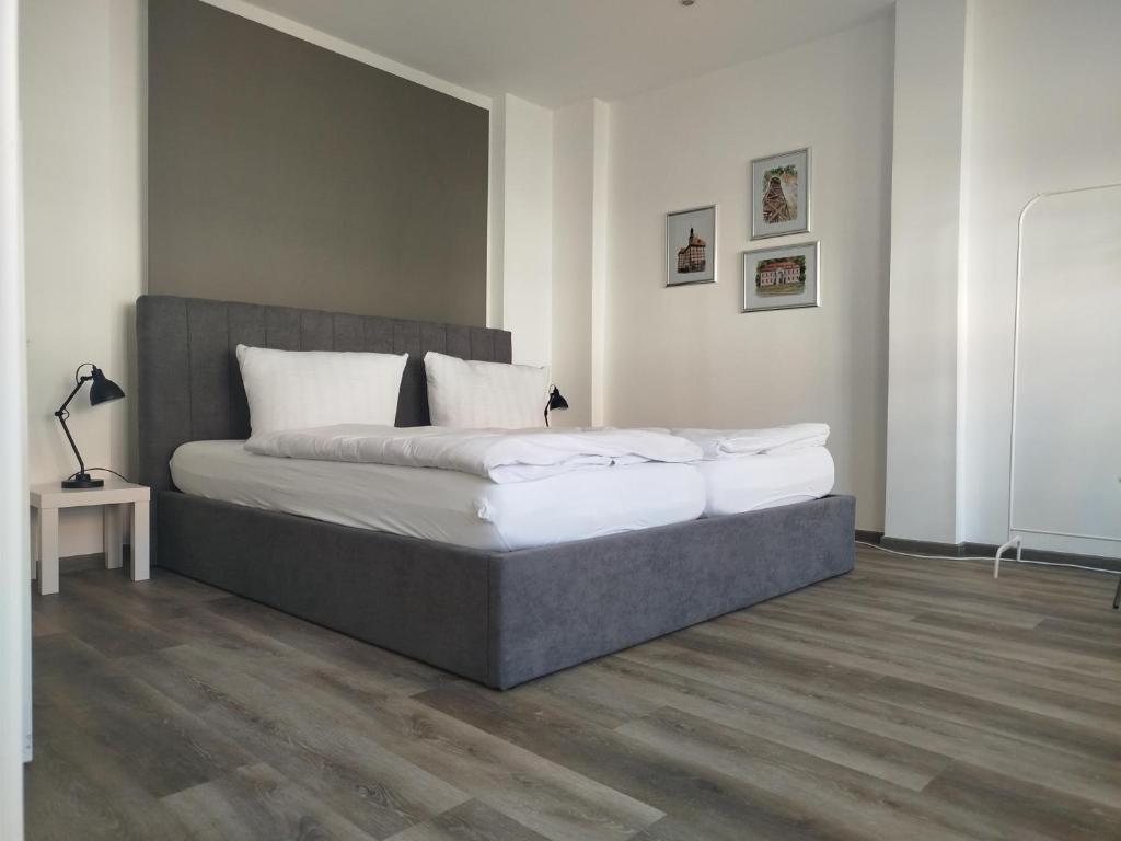 a bedroom with a large bed with white pillows at Ferienwohnung Friederike Luise in Bad Freienwalde