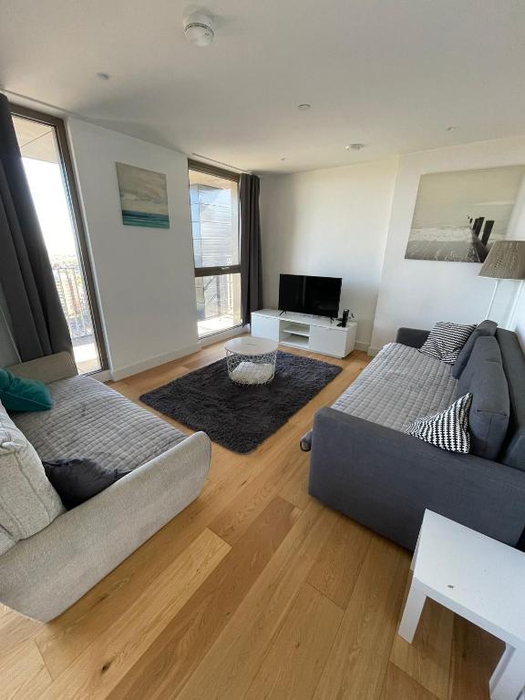a living room with a bed and a couch at LUXURY SERVICED APARTMENT***** in Croydon