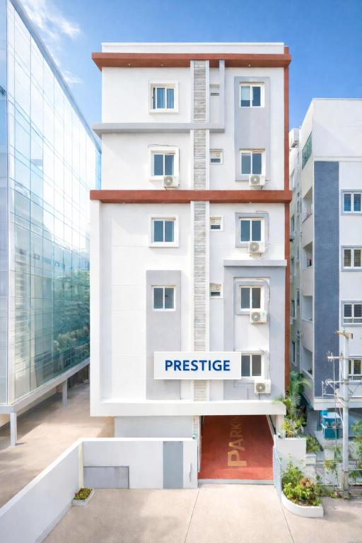 a white building with a sign that reads prestige at New Prestige Hotel in Hyderabad