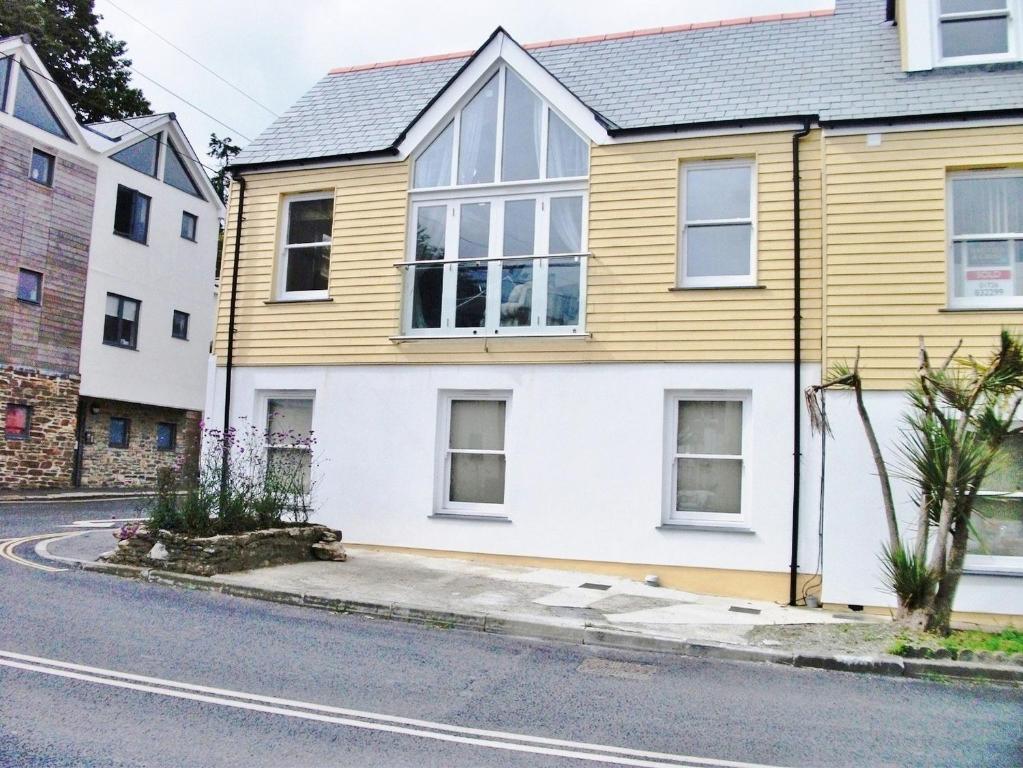 a yellow and white house on the side of a street at Watch House in Fowey