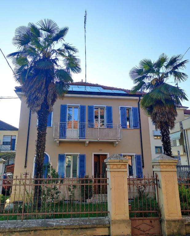 a house with two palm trees in front of it at San bernardo guest house in Fossano