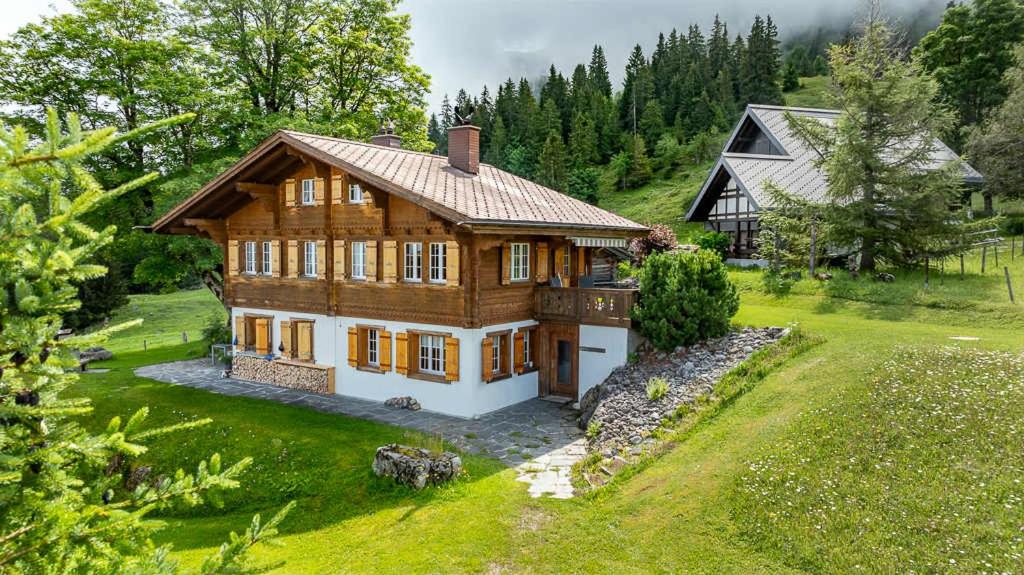an aerial view of a large wooden house at Mountainview Fireplace & Garden Bbq in Axalp