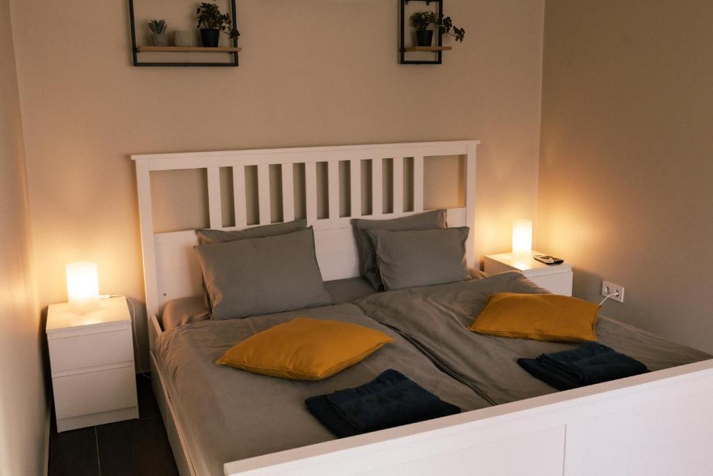 a bedroom with a bed with two pillows on it at Dunavirág Vendégház in Pilismarót