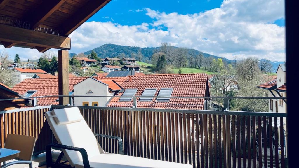a balcony with a view of a town and mountains at FeWo Alpenglühen in Gmund am Tegernsee
