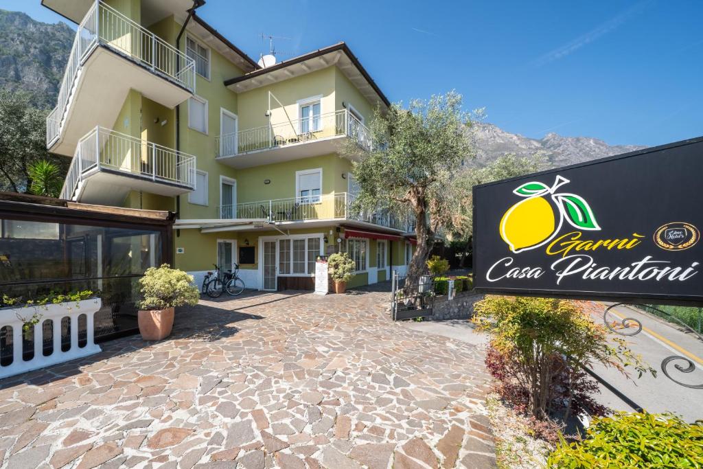 a sign in front of a building at Hotel Casa Piantoni in Limone sul Garda