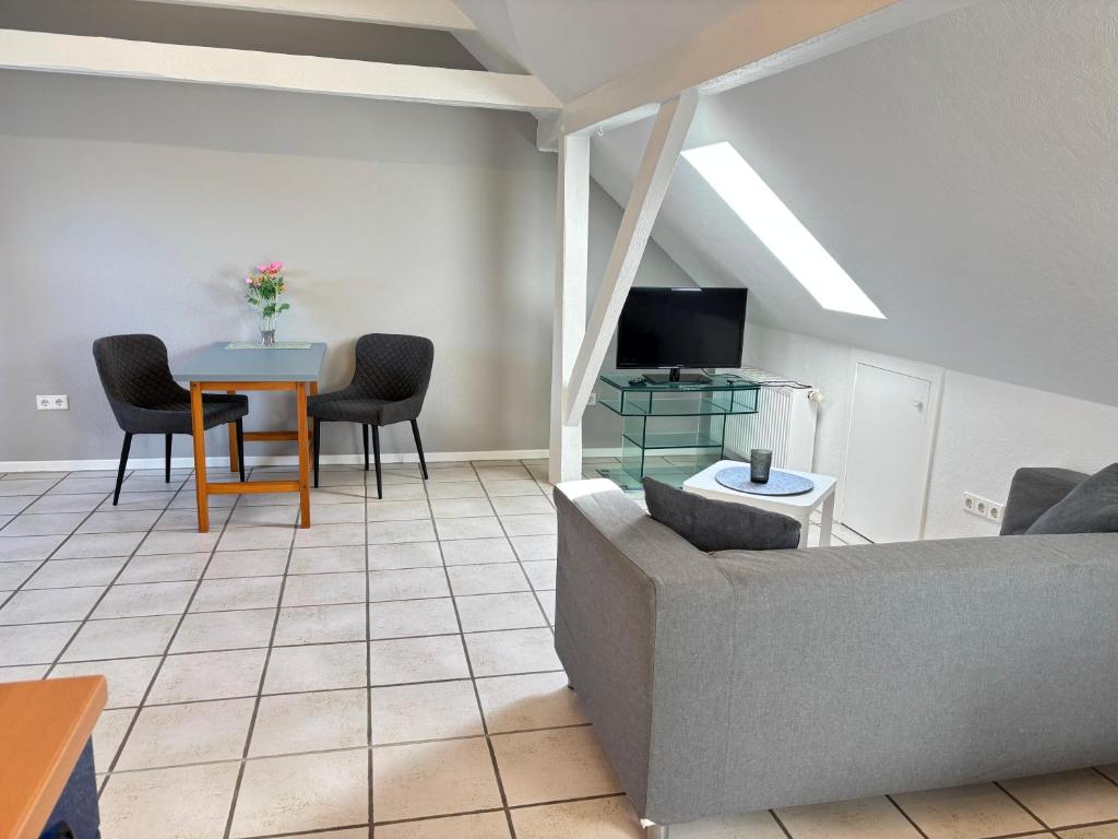 a living room with a couch and a table at Buschhaus Whg 1 in Krummhörn