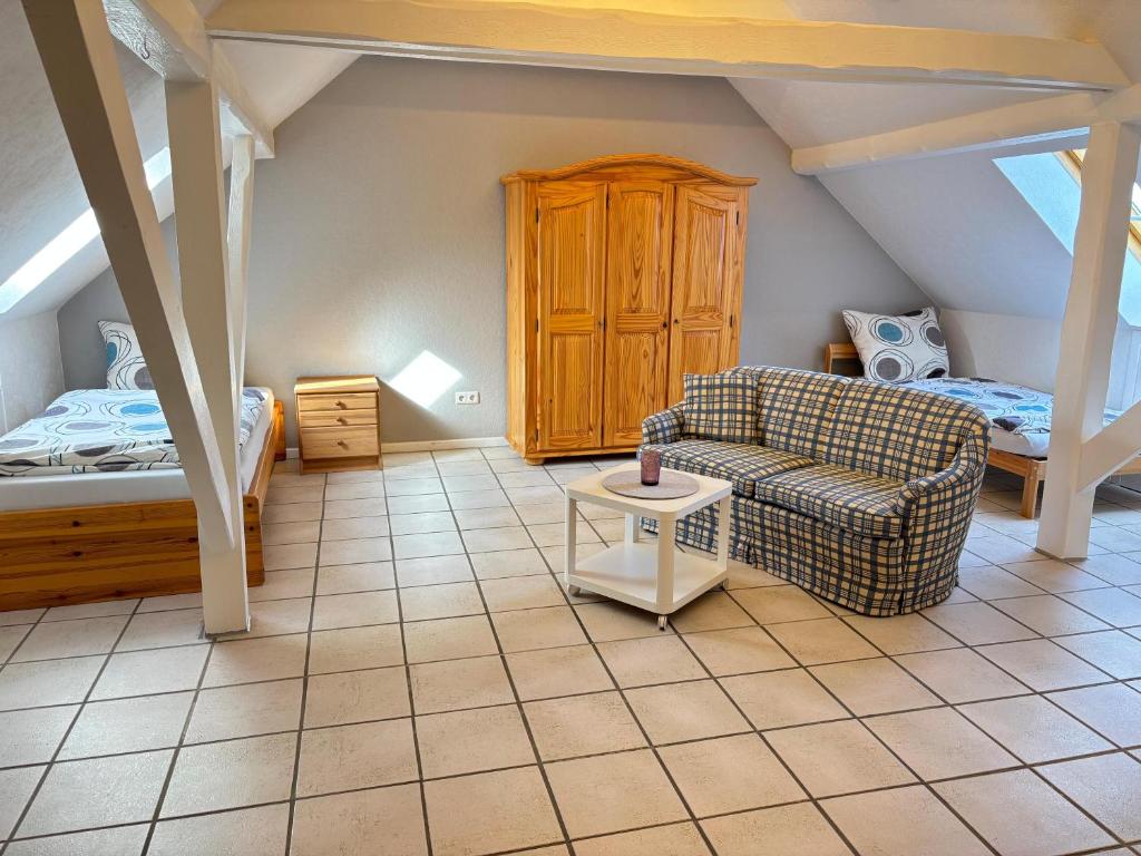 a living room with a couch and a bed at Buschhaus Whg 2 in Krummhörn