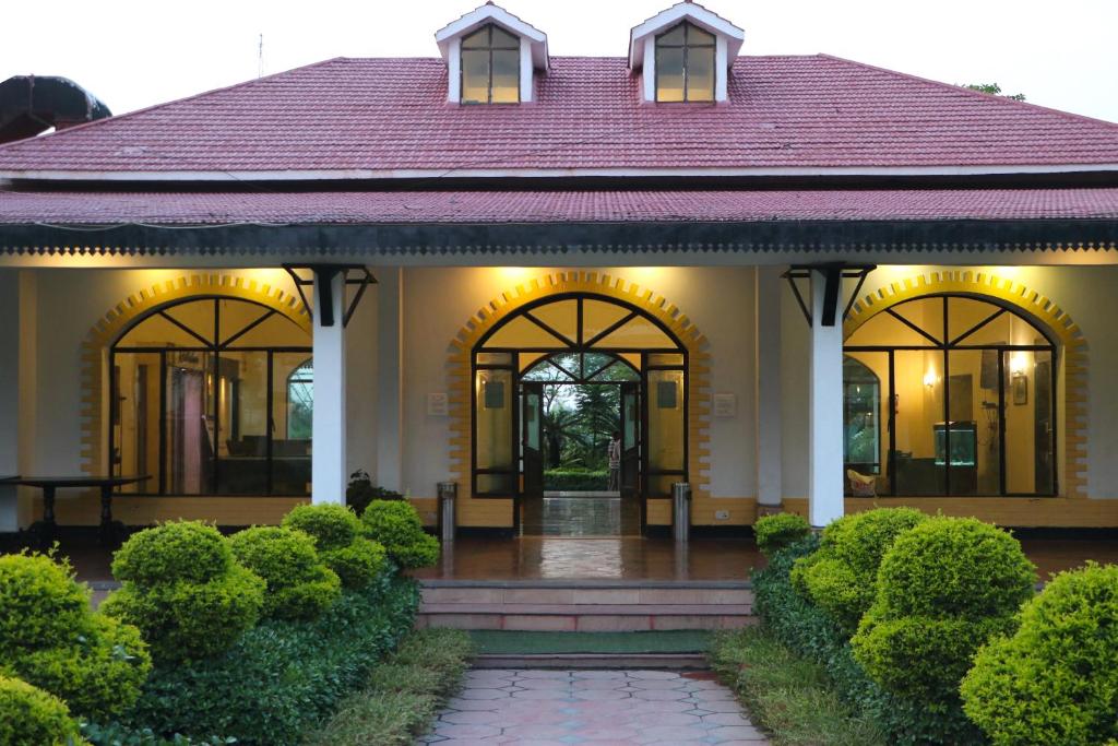 a house with a red roof and a walkway at Orient Resorts in Kānpur