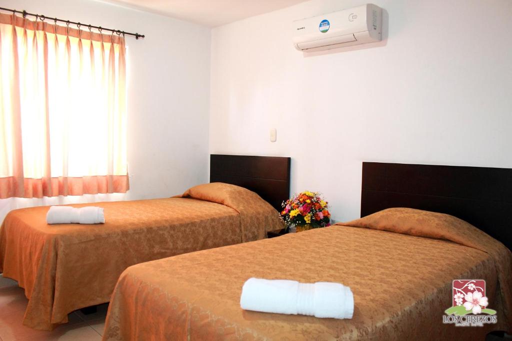 Postel nebo postele na pokoji v ubytování Apartahotel Los Cerezos