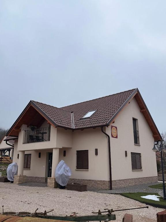 a house with a gambrel roof with a balcony at VillaVino in Szekszárd