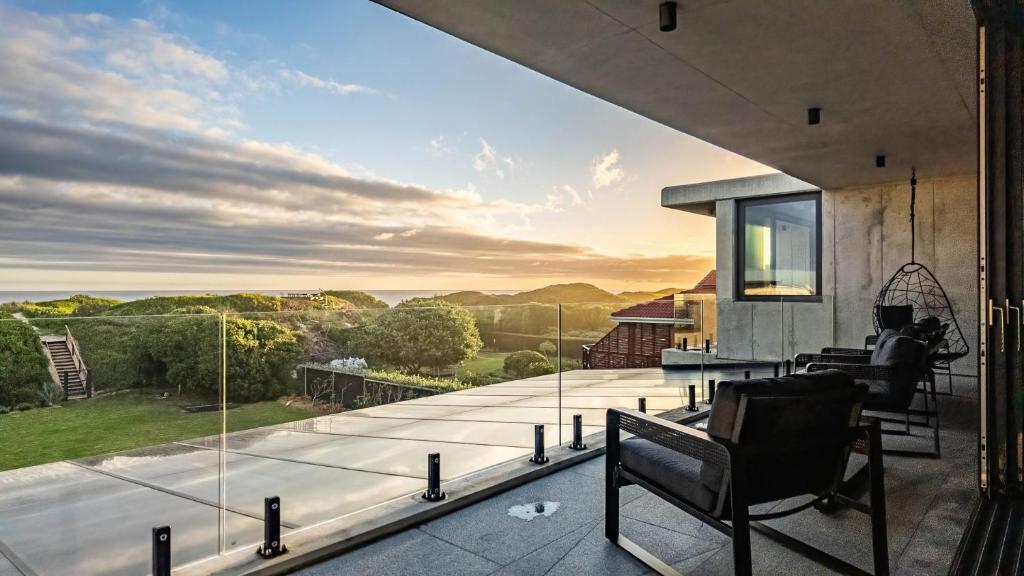a house with a balcony with a view of the ocean at Mi Amor Beach House in Sedgefield