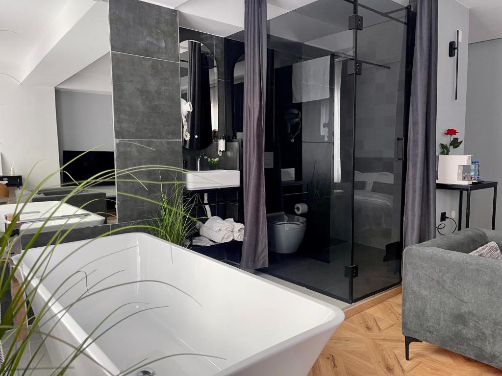 a bathroom with a bath tub and a shower at XIX Boutique Apartment in Skopje