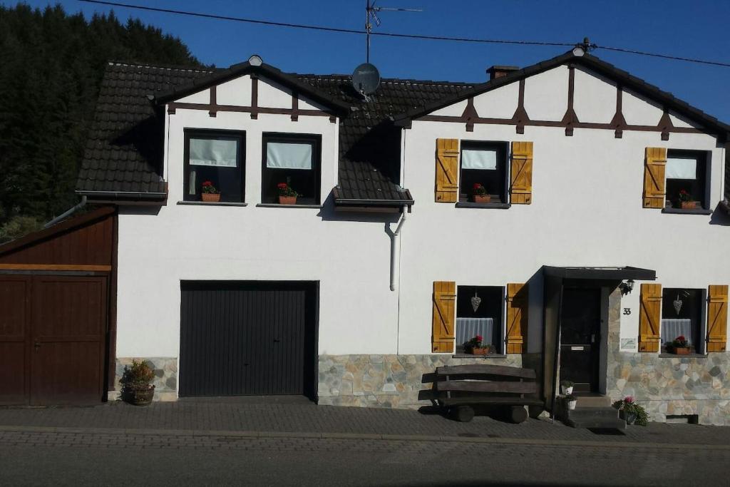 a large white house with windows and a garage at Jüttis in Wimbach