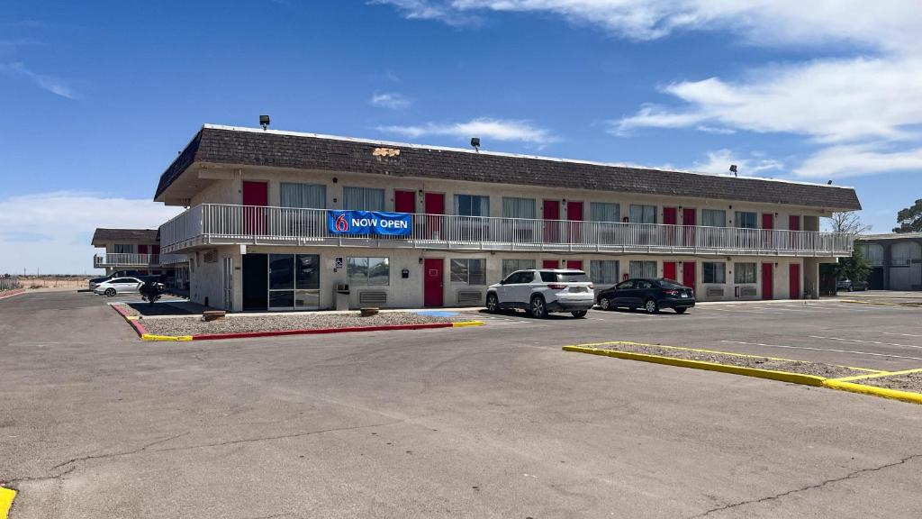 a building with a car parked in a parking lot at Motel 6 - Pecos, TX in Pecos