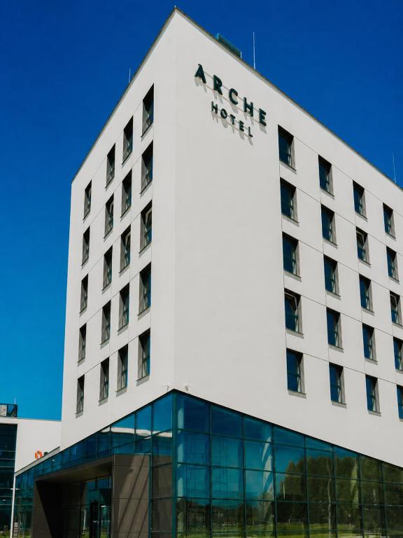 a hotel building with a sign on it at Arche Hotel Lotnisko Gdańsk in Gdańsk-Rębiechowo