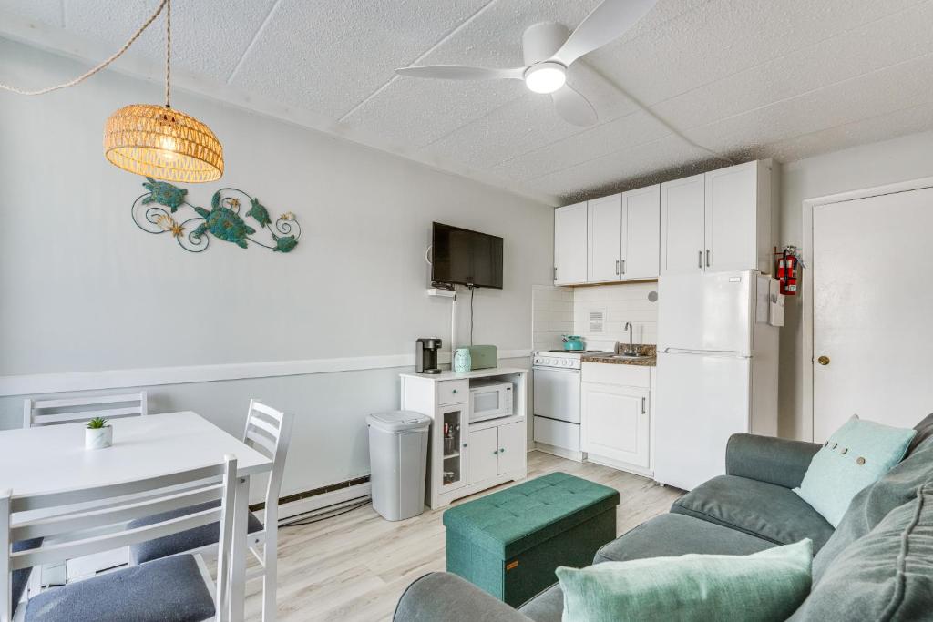 a living room with a couch and a table and a kitchen at Beachfront Wildwood Crest Condo w/ Pool Access! in Wildwood Crest