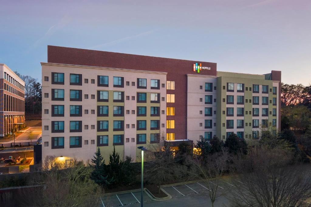 a hotel building with a sign on top of it at EVEN Hotel Alpharetta - Avalon Area by IHG in Alpharetta