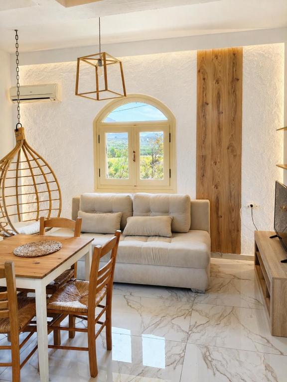 a living room with a couch and a table at Greek Blue Apartment! small apartment, small bathroom in Plakias