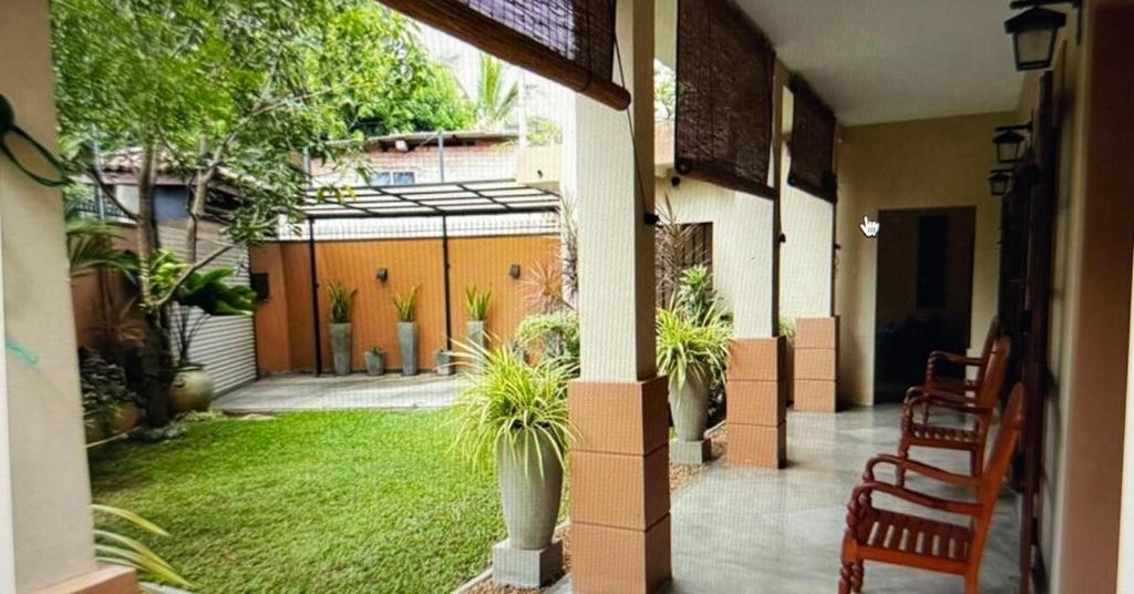 a porch of a house with a yard with plants at Chevita Villa in Malabe