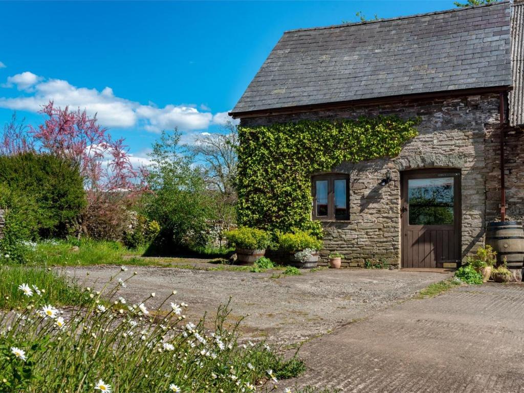 a stone house with ivy on the side of it at 1 Bed in Brecon oc-bn336 in Talgarth